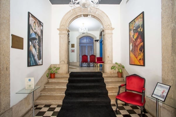 a hallway with stairs and a red chair