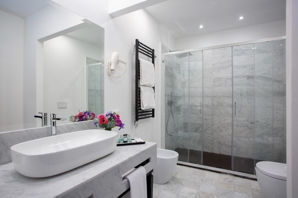 a bathroom with a sink a toilet and a shower