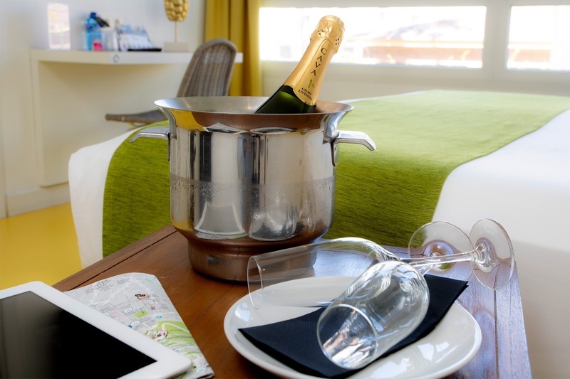 a bottle of cava is in a bucket on a table