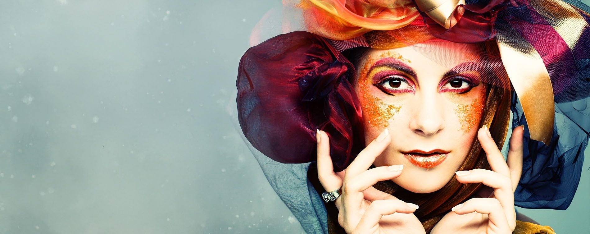 a close up of a woman 's face with colorful makeup