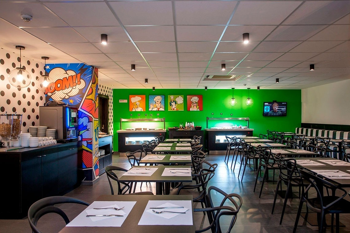 a restaurant with tables and chairs and a sign that says boom