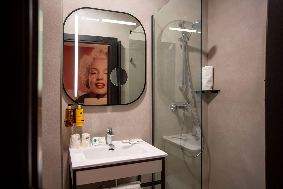 a bathroom with a picture of marilyn monroe on the mirror