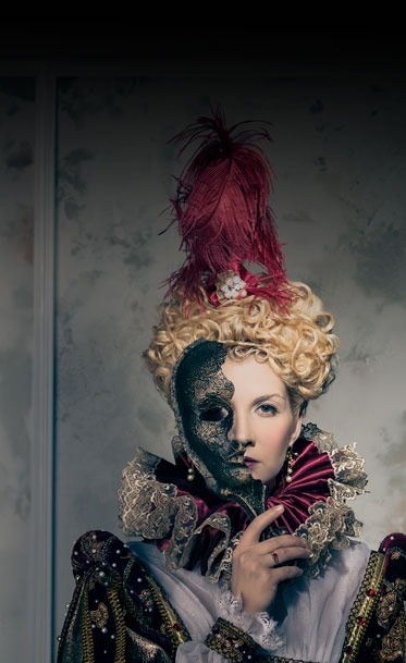 a woman with a mask on her face holds a fan