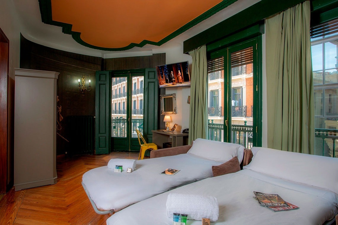 a hotel room with two beds and a magazine that says ' netflix ' on it