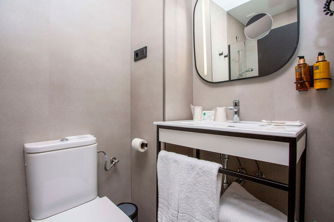 a bathroom with a toilet a sink and a mirror
