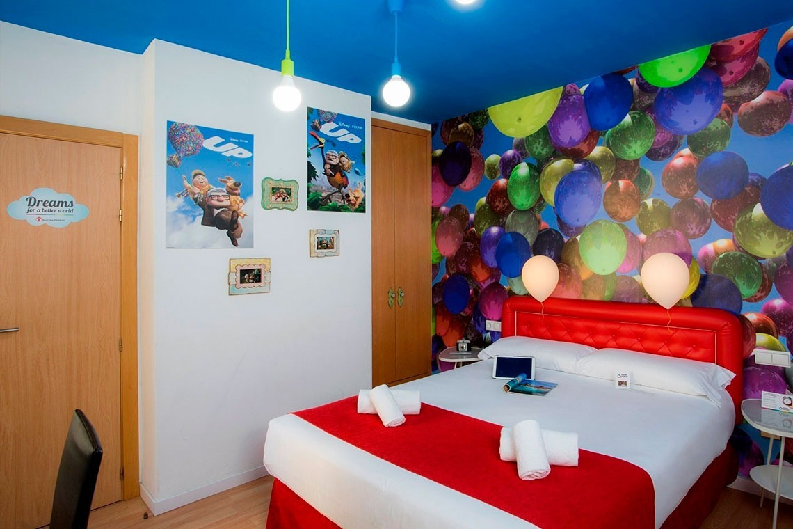 a bedroom with balloons on the wall and a sign that says dreams on the wall