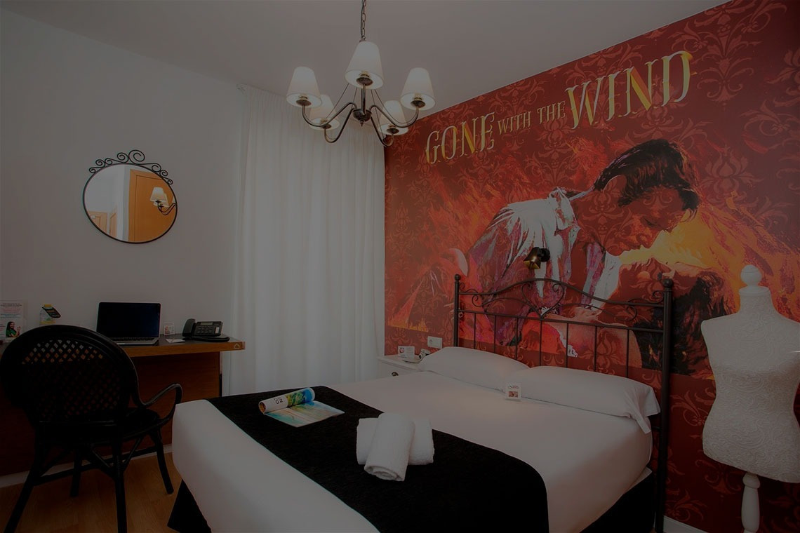 a bedroom with a poster on the wall that says gone with the wind