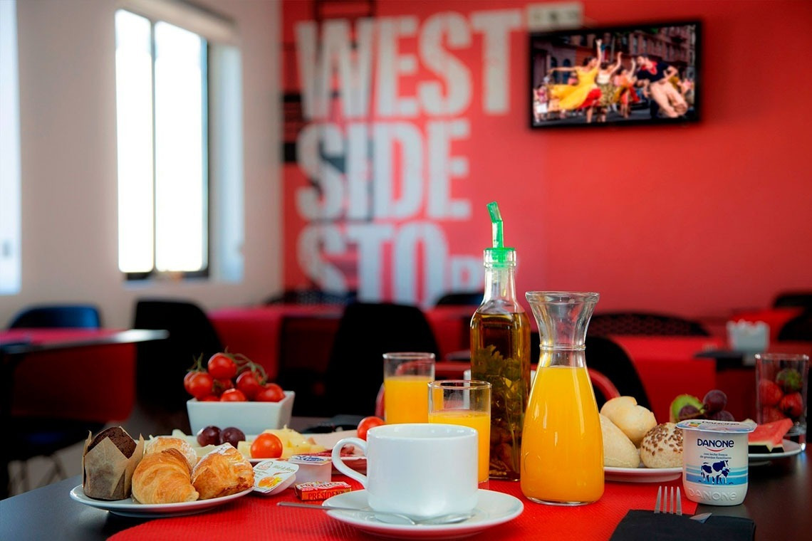 a breakfast table with a sign on the wall that says west side story