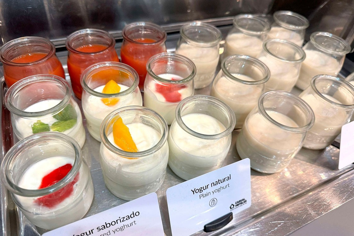 several jars of yogurt are lined up on a tray