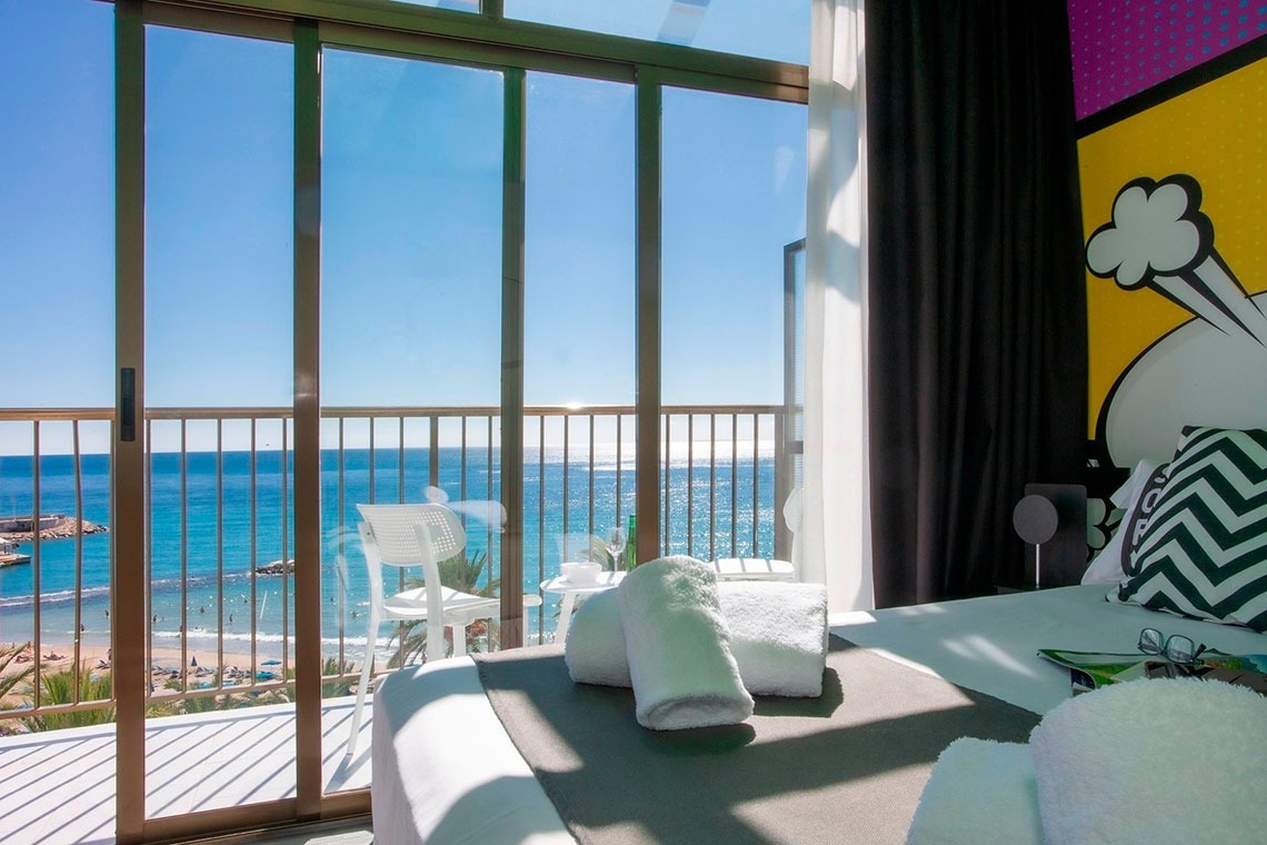 a hotel room with a view of the ocean