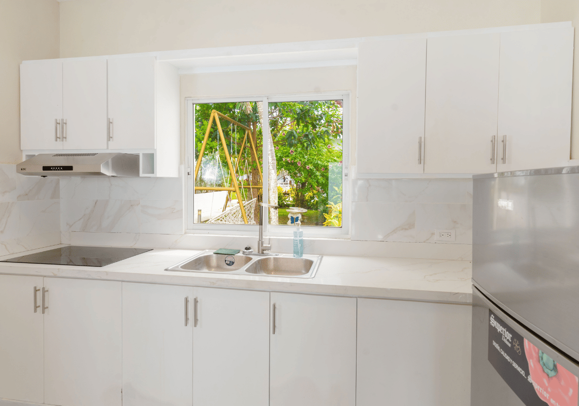 Cocina moderna del hotel con ventana y vista al exterior, ideal paraCasual: Green Village Bayahibe.