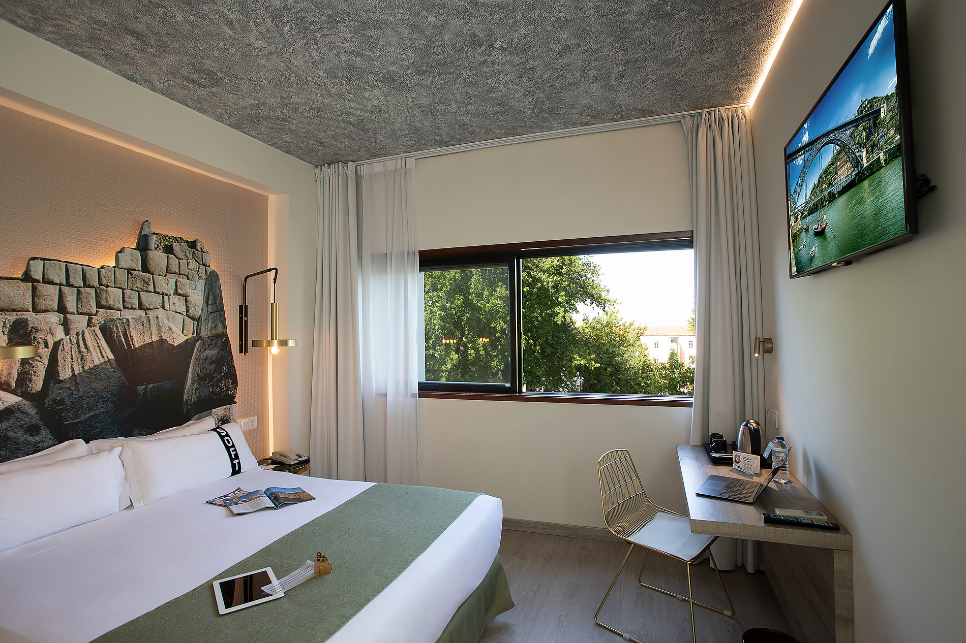 Habitación cómoda conCasual: Inca Porto: cama, TV y escritorio.