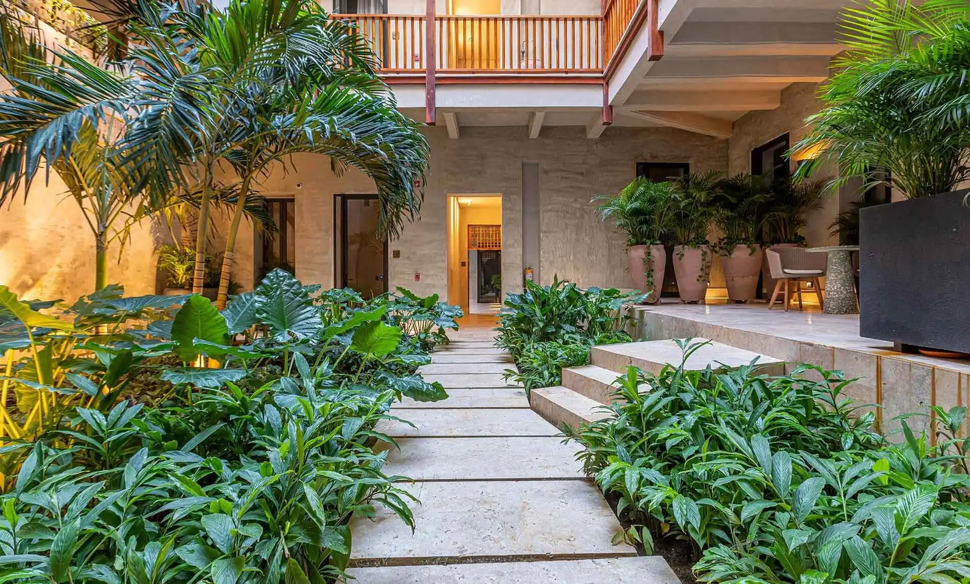 Tropical courtyards at Cinco Quintas Hotel Boutique. Lush greenery and pathways.