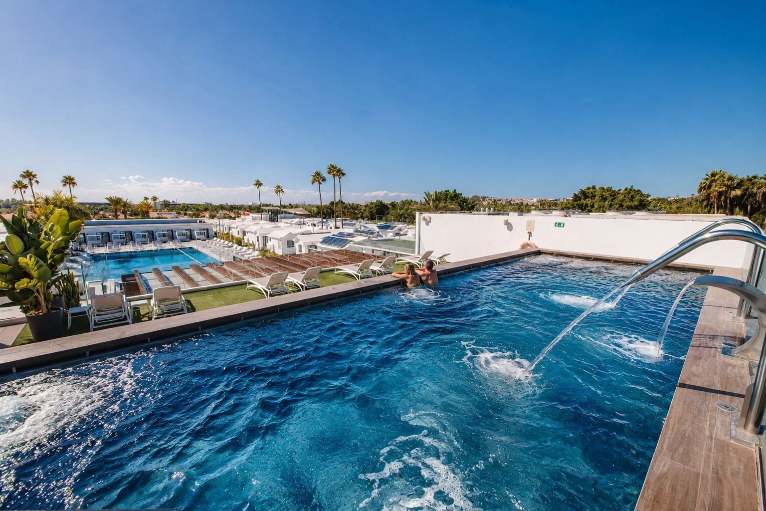 Couple relaxing in a heated pool at Club Maspalomas.