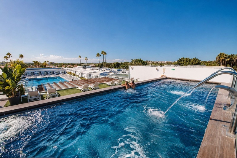Couple relaxing in a heated pool at Club Maspalomas.