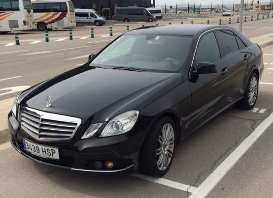 una camioneta mercedes con las puertas abiertas está estacionada en un estacionamiento