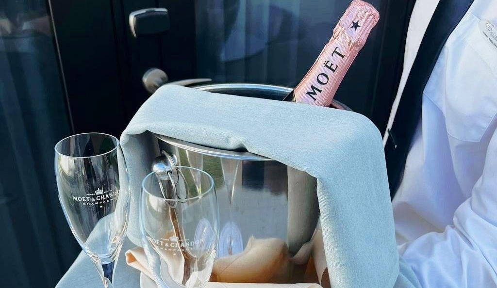 a bottle of moet sits in an ice bucket