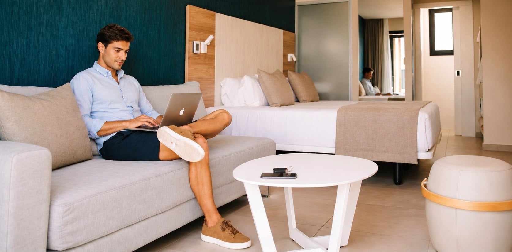 Man working on laptop in modern hotel room at Club Maspalomas.