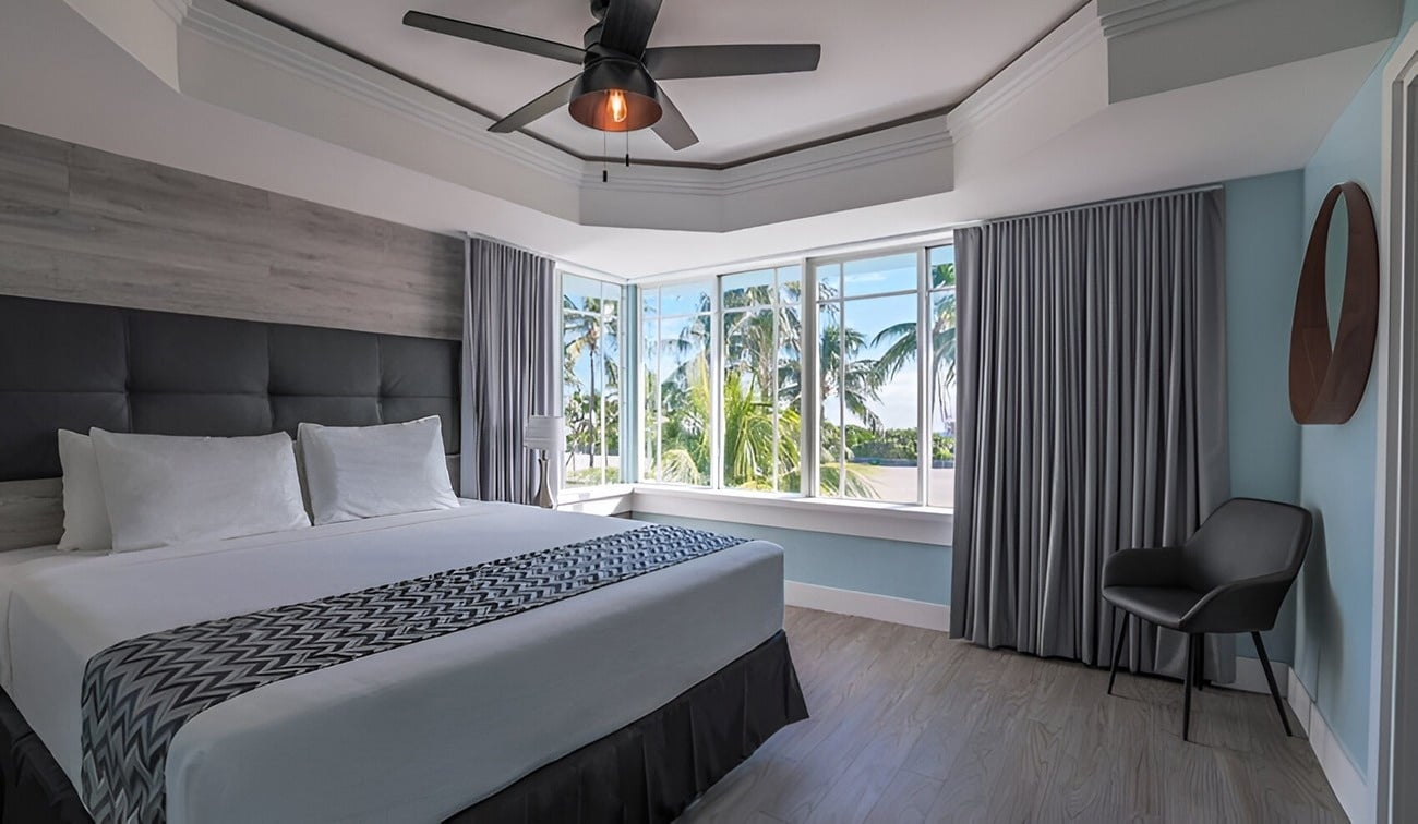 a hotel room with a bed and a mirror