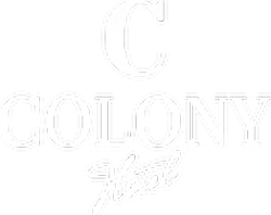 the logo for the colony hotel is white on a black background