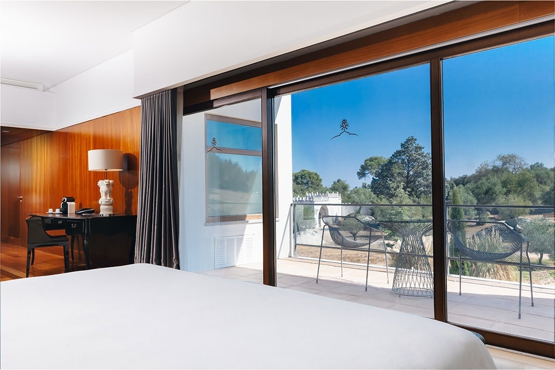 a hotel room with a sliding glass door leading to a balcony