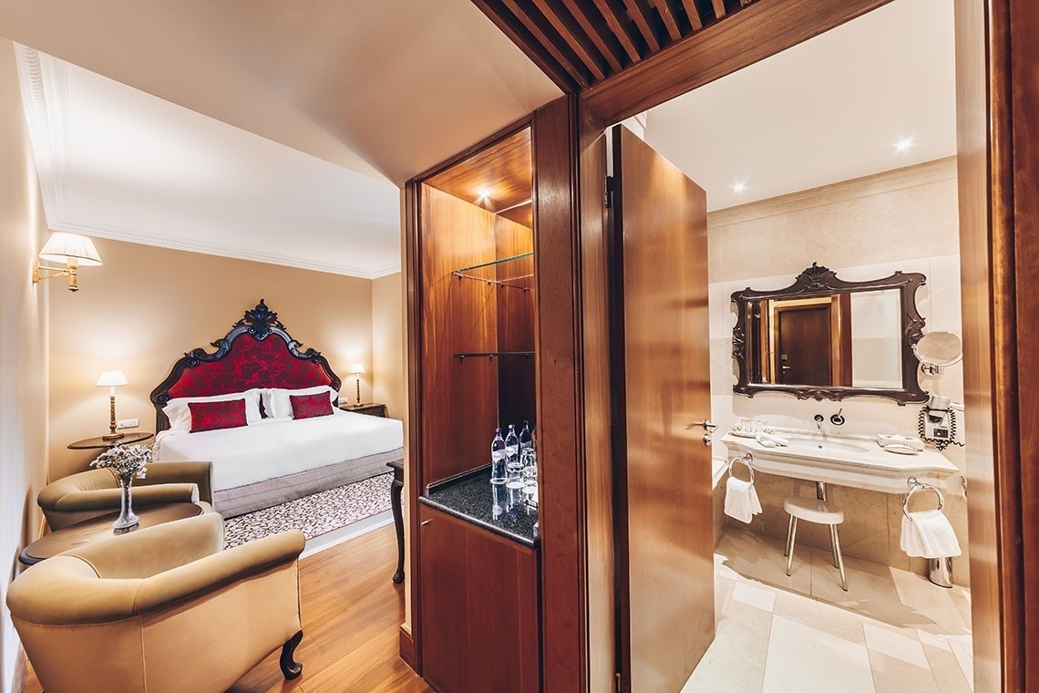 a hotel room with a king size bed and a bathroom