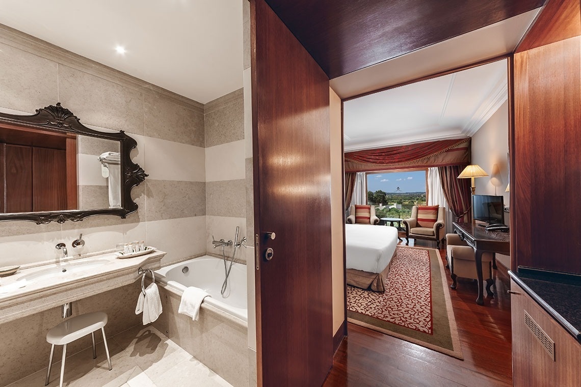 a bathroom with a bathtub and a mirror