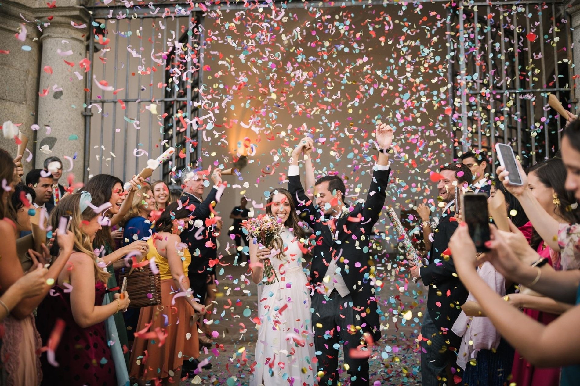 a bride and groom are being showered with confetti