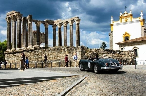 a large white building with a blue sky in the background
