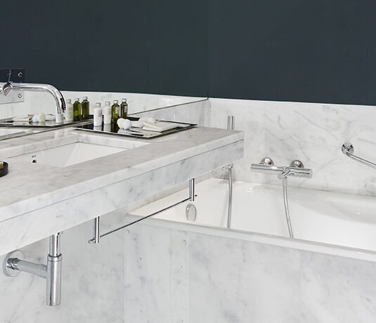 a hotel room with a large bed and a balcony