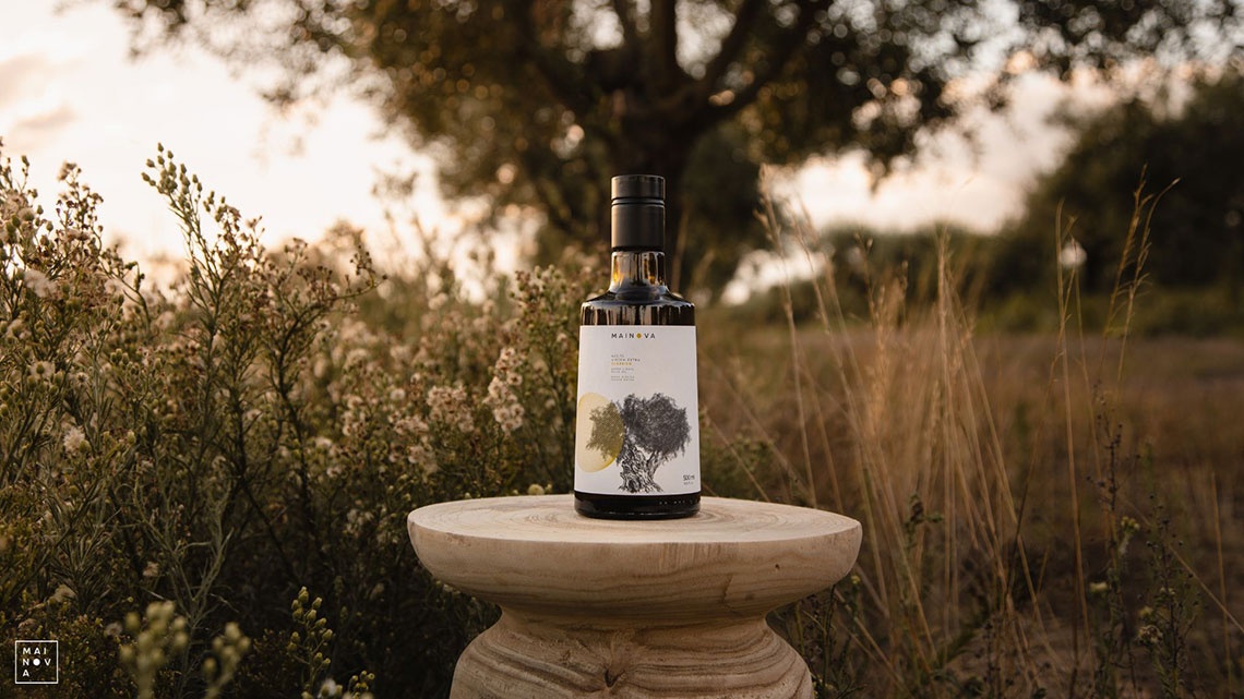 Convento do Espinheiro: Olive oil bottle on a wooden pedestal in a natural setting.