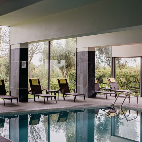 una piscina cubierta con sillas y una señal que dice 