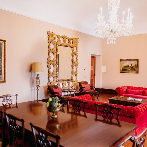 una sala de estar con sofás rojos y una mesa de comedor