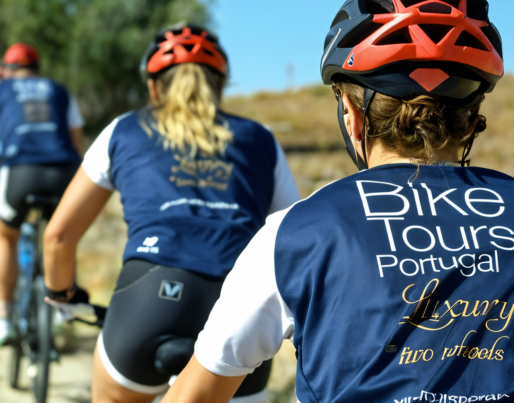 a woman wearing a blue shirt that says bike tours portugal