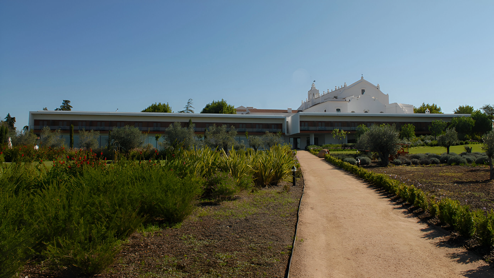 a path leads to a large white building