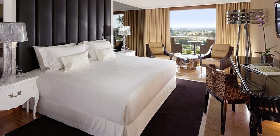 a hotel room with two beds and a bathroom