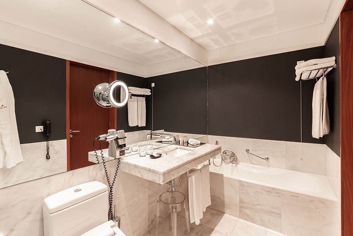 a bathroom with a toilet a sink and a mirror