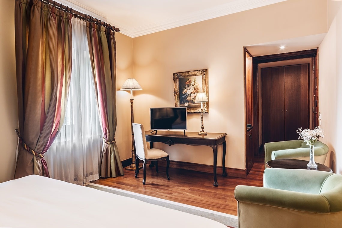 a hotel room with a large bed and a balcony