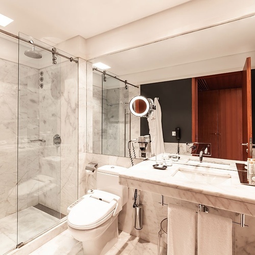 un baño con inodoro y ducha de vidrio