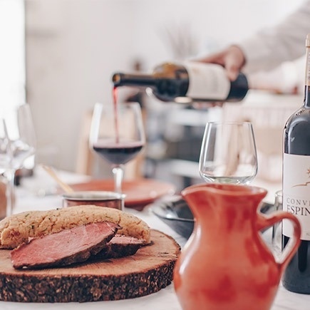 a bottle of conve espin wine is poured into a glass