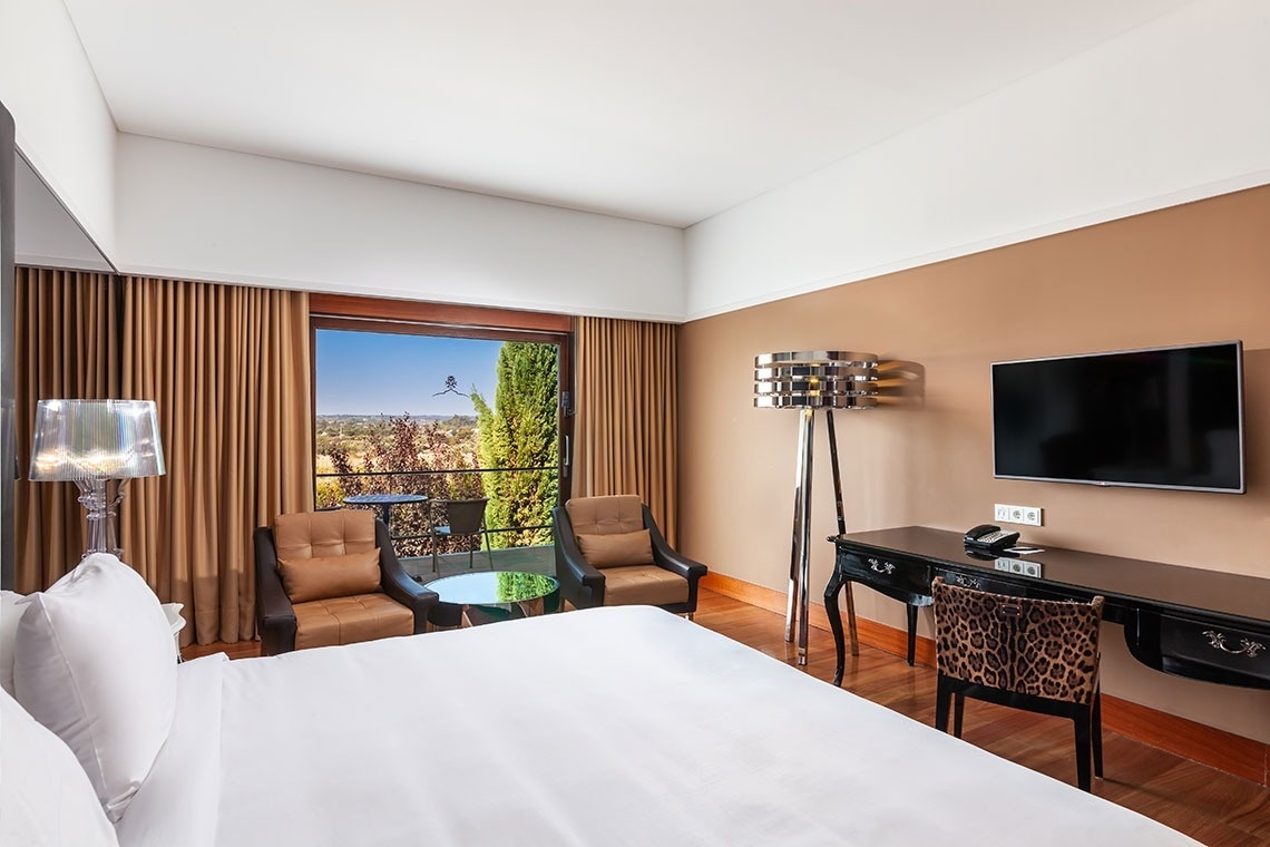 a hotel room with a large bed and a flat screen tv