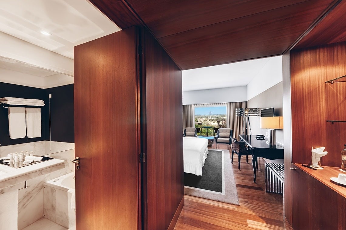 a hotel room with a king size bed and a desk