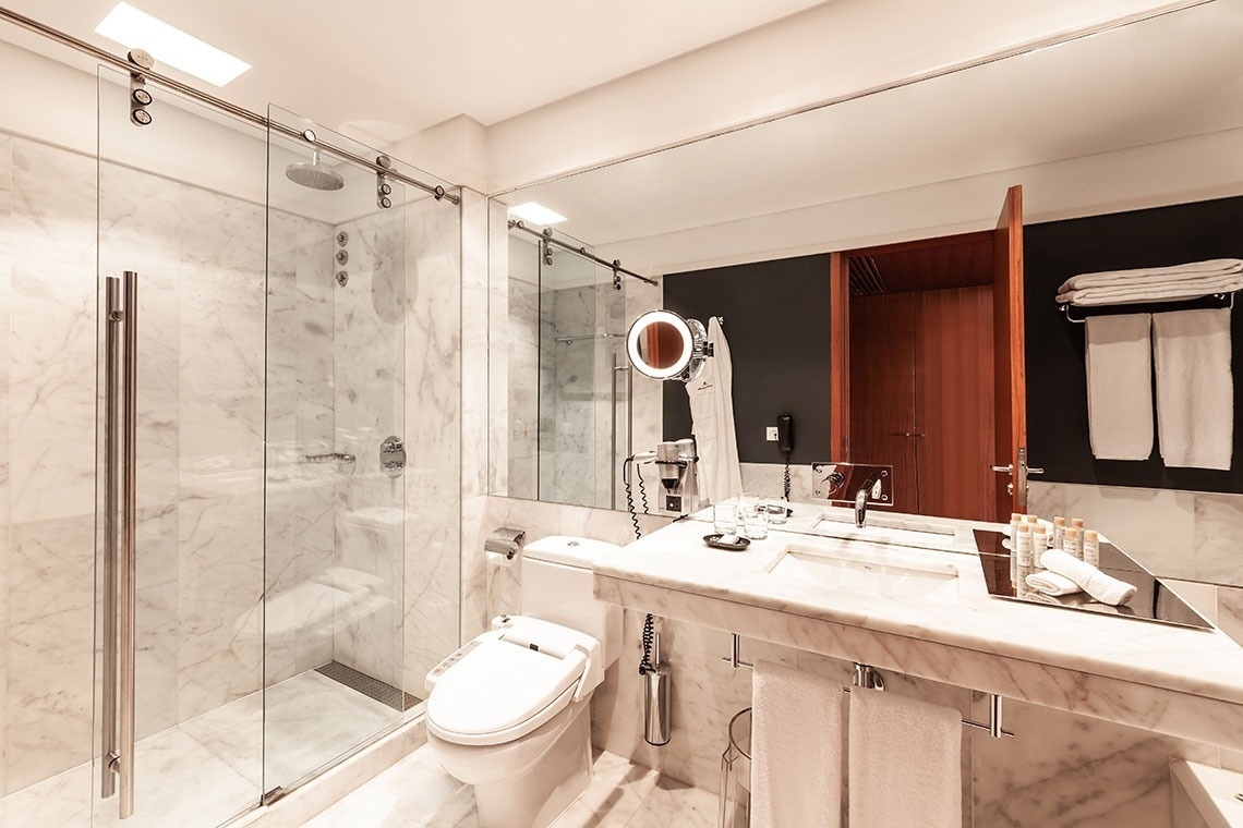 a bathroom with a toilet a sink and a mirror