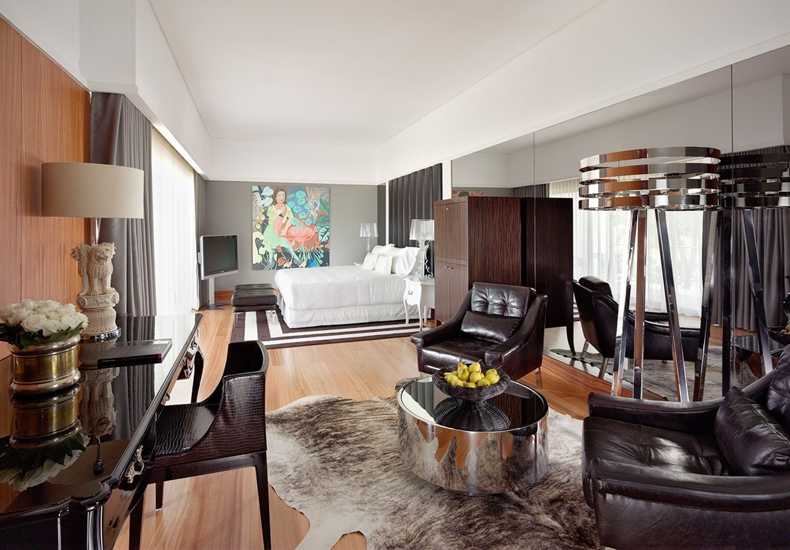 a bedroom with a painting on the wall above the bed