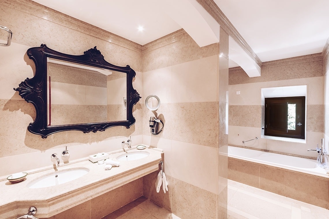 a bathroom with two sinks and a large mirror