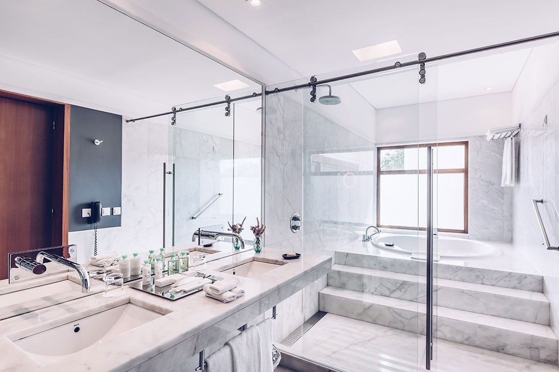 a bathroom with a sliding glass shower door