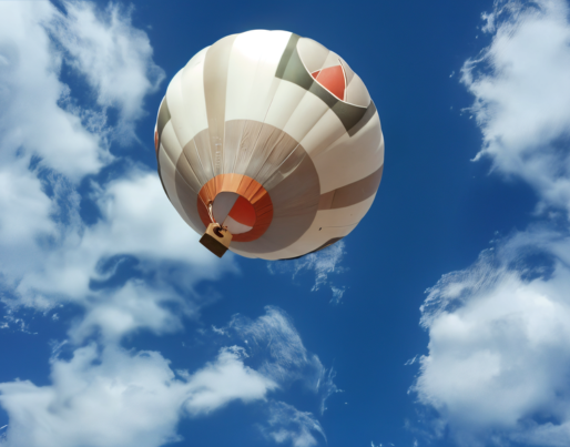 a hot air balloon is flying through a cloudy blue sky .