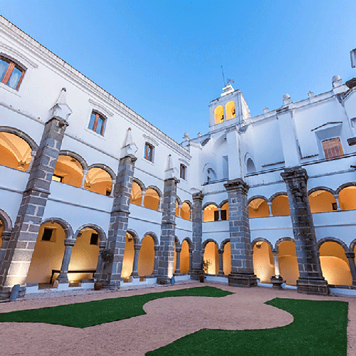un edificio blanco con columnas negras y arcos
