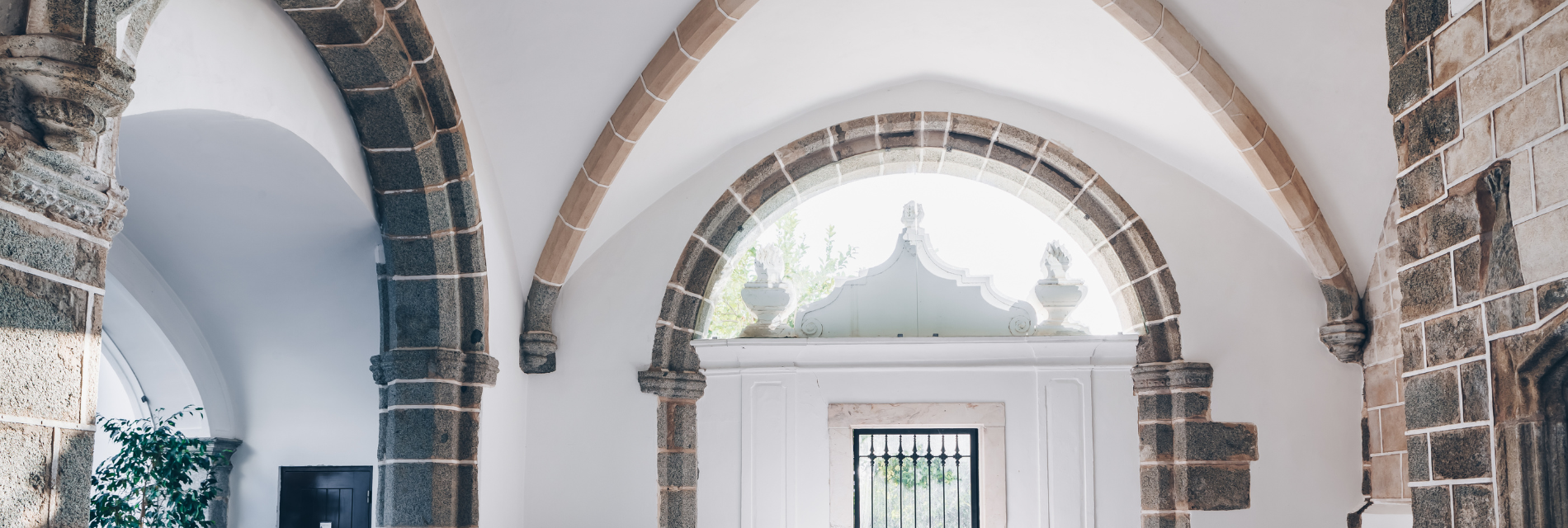 a stone archway in a building with a window