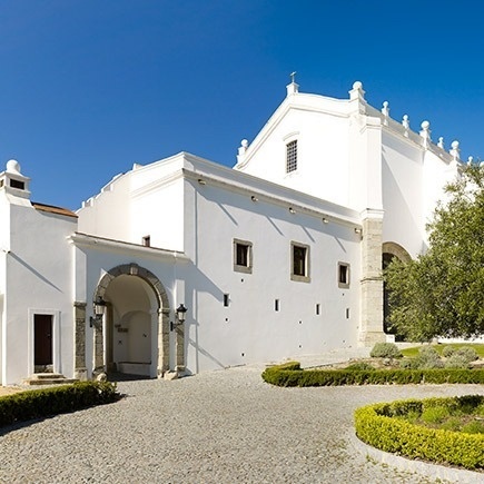 a large white building with a blue sky in the background